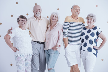 Wall Mural - Smiling senior friends hugging each other. Meeting of elderly people