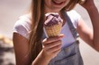 © Wavebreak Media - Girl hand holding waffle cone with ice cream on a sunny day