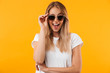 © Drobot Dean - Portrait of an excited young blonde girl in sunglasses