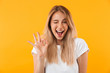 canvas print picture - Portrait of a happy young blonde girl showing ok gesture
