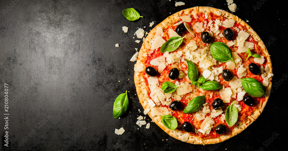 Traditional italian pizza on dark table - obrazy, fototapety, plakaty 