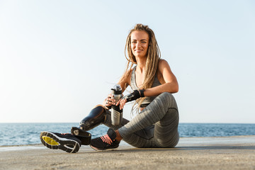 Wall Mural - Smiling disabled athlete woman with prosthetic leg