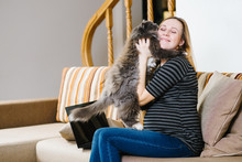 A Caucasian Pregnant Woman Hugs A Cat