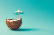 Leinwandbild Motiv Tropical beach concept made of coconut fruit and sun umbrella. Creative minimal summer idea.
