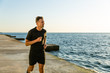 © LIGHTFIELD STUDIOS - adult sportsman jogging on seashore in morning