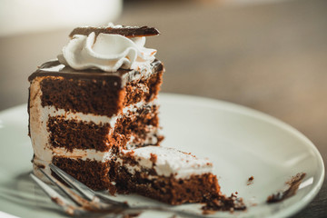 Close up of woman eating chocolate cherry cake . Delicious chocolate cake in white plate. food, junk-food, culinary, baking and holidays concept