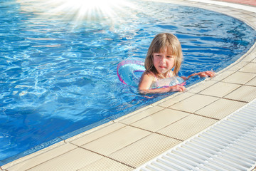 a happy child plays by the pool by the sea