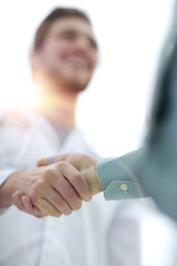 closeup.handshake between doctor and patient.