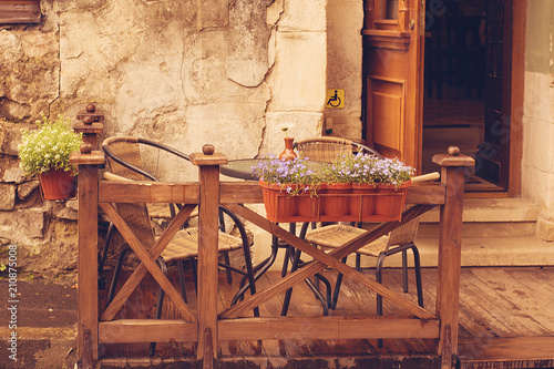 Fényképezés Chairs and a table on the background of an old wall.