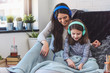 © lordn - Girls having fun at home, listening music over smart phone. Family quality time
