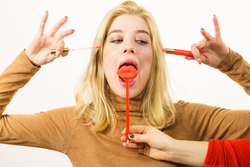 Wall Mural - Woman applying lipstick or lip gloss