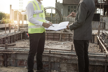 Engineer and Architect working at Construction Site