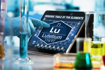 Sticker - researcher working on the digital tablet data of the chemical element Lutetium Lu / researcher working on the computer with the periodic table of elements 