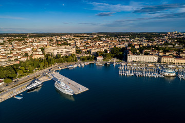 Canvas Print - City of Pula aerial view from above the sea by a professional drones, Istria, Croatia.