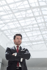 confident businessman standing in a spacious office