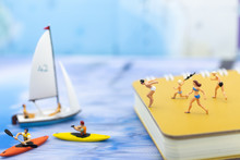 Miniature People : Travelers Have Activities On The Beach And Swimming On Blue Ocean. Image Use For Sport, Vacation ,travel Concept.