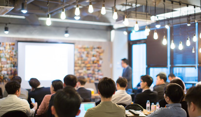Fototapete - Presenter Presenting on Stage at Conference Meeting. Professional Lecture. Blurred De-focused Unidentifiable Presenter and Audience. Corporate Executive Manager Speaker. People Attendees