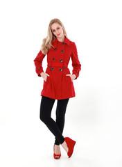 Canvas Print - portrait of pretty blonde girl wearing red trench coat, full length standing pose.. isolated on white studio background.