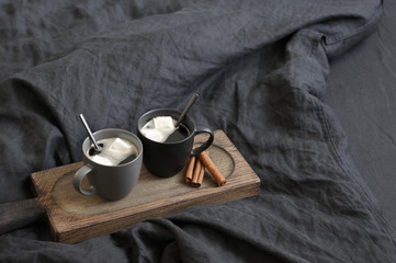 Wall Mural - Two coffee mug in dark grey bed