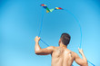 © LIGHTFIELD STUDIOS - back view of man with colorful kite against clear blue sky
