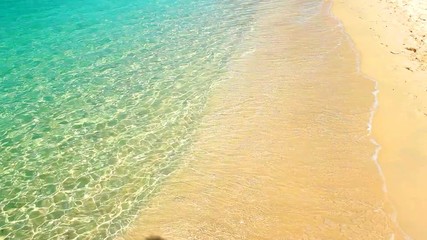 Canvas Print - Soft waves with foam of blue ocean on the sandy beach summer background.