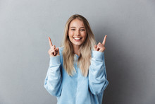 Portrait Of A Cheerful Young Girl In Blue Sweatshirt