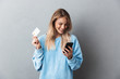 © Drobot Dean - Pretty young blonde girl in blue sweatshirt