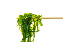 Seaweed Salad On Wooden Chopsticks Isolated On White Background