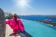 © Santorines - Young woman in red dress
