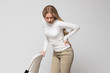 © DimaBerlin - Woman having muscle or chronic nerve pain in her back, holding chair, isolated on gray background. Diseases of spine, scoliosis, osteoporosis