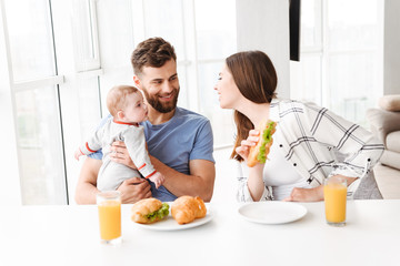 funny young loving couple parents with their little baby son