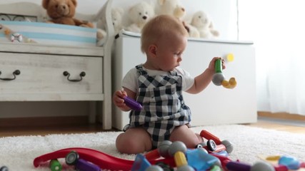 Wall Mural - Sweet baby boy, toddler child, playing at home with lots of different toys