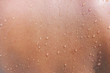 Leinwandbild Motiv Water drops on woman skin, close up of wet human skin texture

