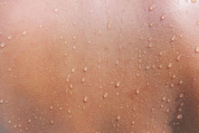 Water Drops On Woman Skin, Close Up Of Wet Human Skin Texture
