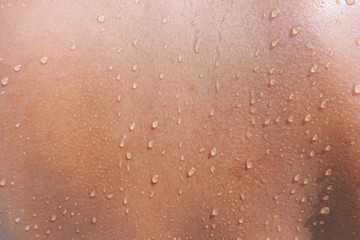 water drops on woman skin, close up of wet human skin texture