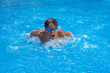 © RaDa - Close up action shot of boy swimming butterfly style.