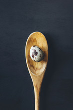 Fresh Quail Egg With Wooden Spoon On Black Background. Healthy Food, Farmer's Organic Product