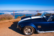 Vingtage Classic Sport Car With San Francisco Golden Gate Bridge On Foggy Background View From Marin Headland