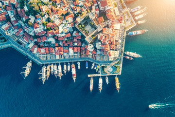 Wall Mural - Aerial view of boats, yachts, floating ship and beautiful architecture at sunset in  Turkey. Landscape with boats in marina bay, sea, buildings in city. Top view of harbor with sailboat and houses.