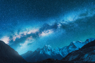 Wall Mural - milky way and snowy mountains. fantastic view with mountain ridge and starry sky at night in nepal. 