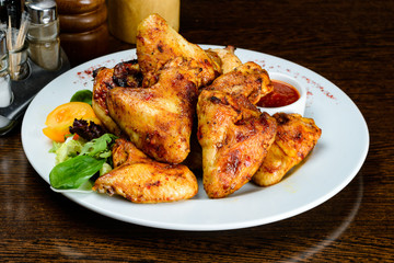 Wall Mural - Appetizing spicy baked chicken wings with sweet chili sauce on t