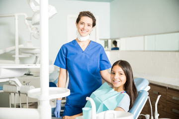 Wall Mural - Portrait Of Smiling Dentist And Teenage Girl In Clinic