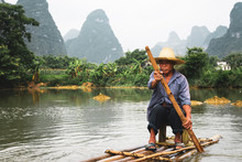 Chinese Man Sitting On Raft On Quây Son