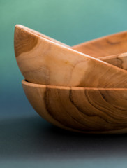 Balinese wooden plates of teak on a green background.