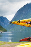 Fototapeta Natura - Many canoes on norwegian fjord shore
