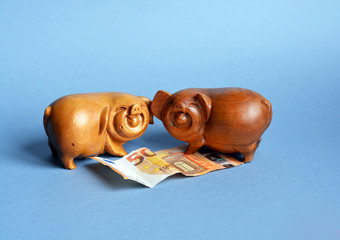 Two fun wooden pigs with money, congratulations happy new year, symbol of the year, banner, greeting card for text