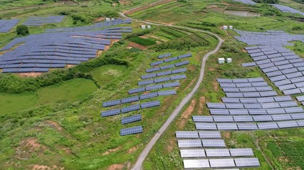 Poster - aerial video of renewable energy landscape of solar power station on hillside