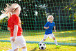 © famveldman - Kids play football. Child at soccer field.