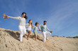 © goodluz - Family running down sand dune