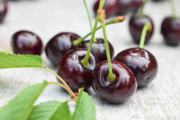 Wall Mural - Spelled cherries on the white wooden background